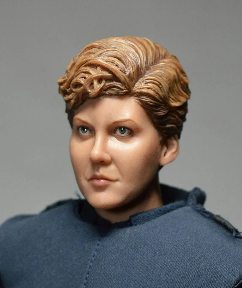 Angled close-up of the custom Anne Lewis head sculpt, showing the swept short hair, painted eyes and cheek detail.