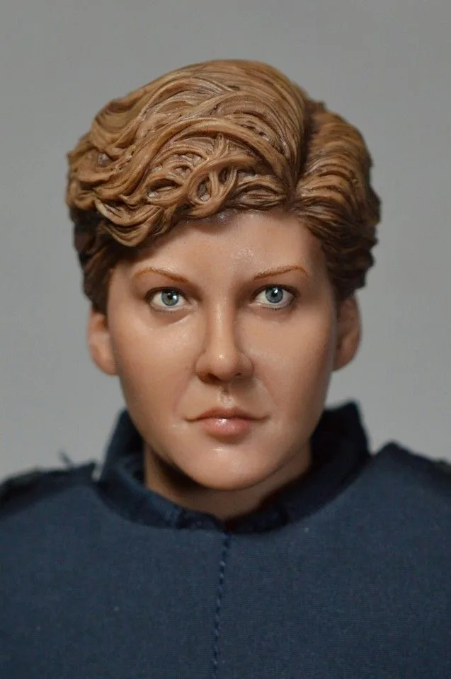Straight-on close-up of the custom Anne Lewis face, with blue painted eyes and layered brown hair above the uniform collar.
