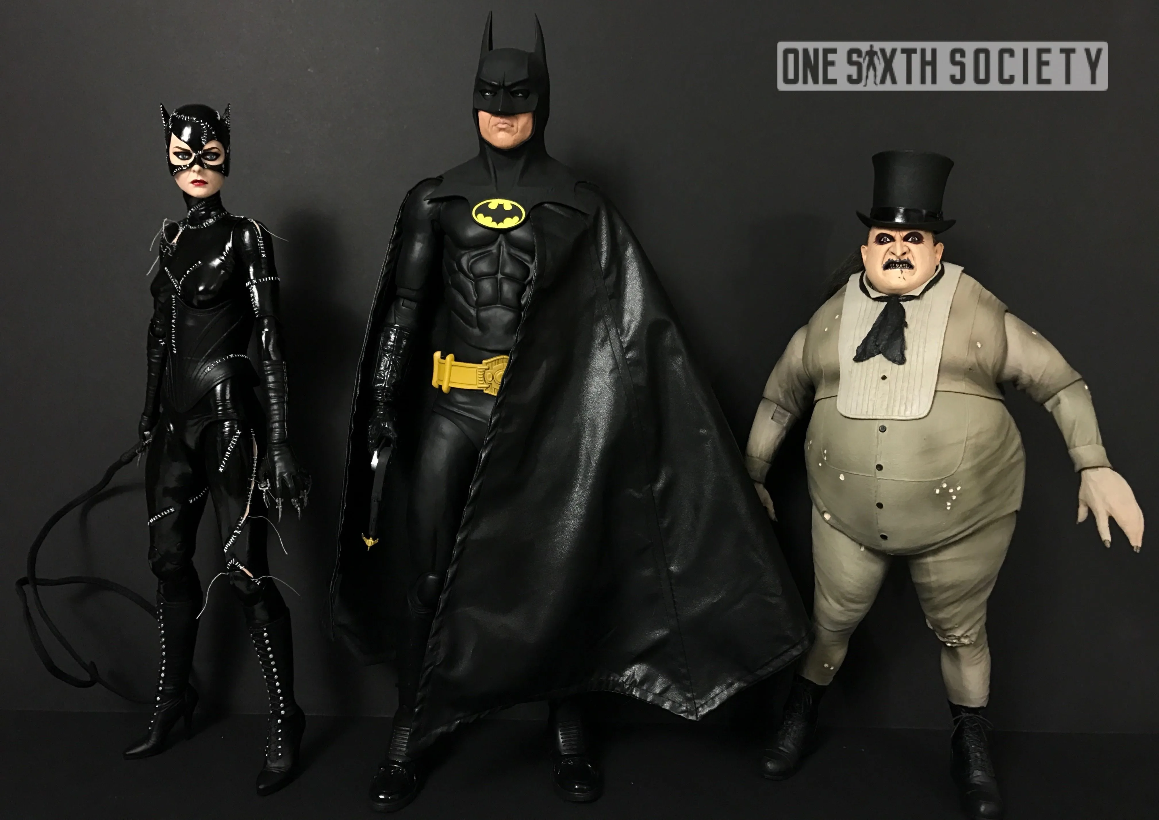 NECA Catwoman, Batman and Penguin figures displayed together, with Catwoman's whip, Batman's cape and Penguin's top hat visible.