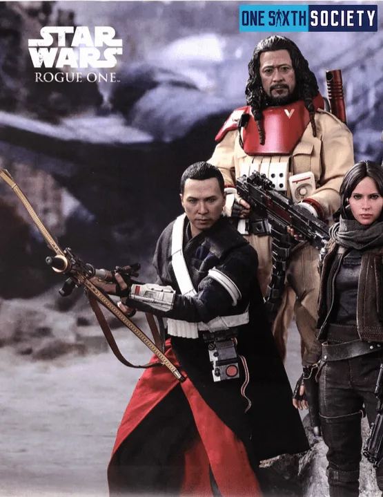 Left side of a Hot Toys Rogue One display with Chirrut Îmwe and Baze Malbus among rocky scenery and Jyn Erso partly visible at the edge.