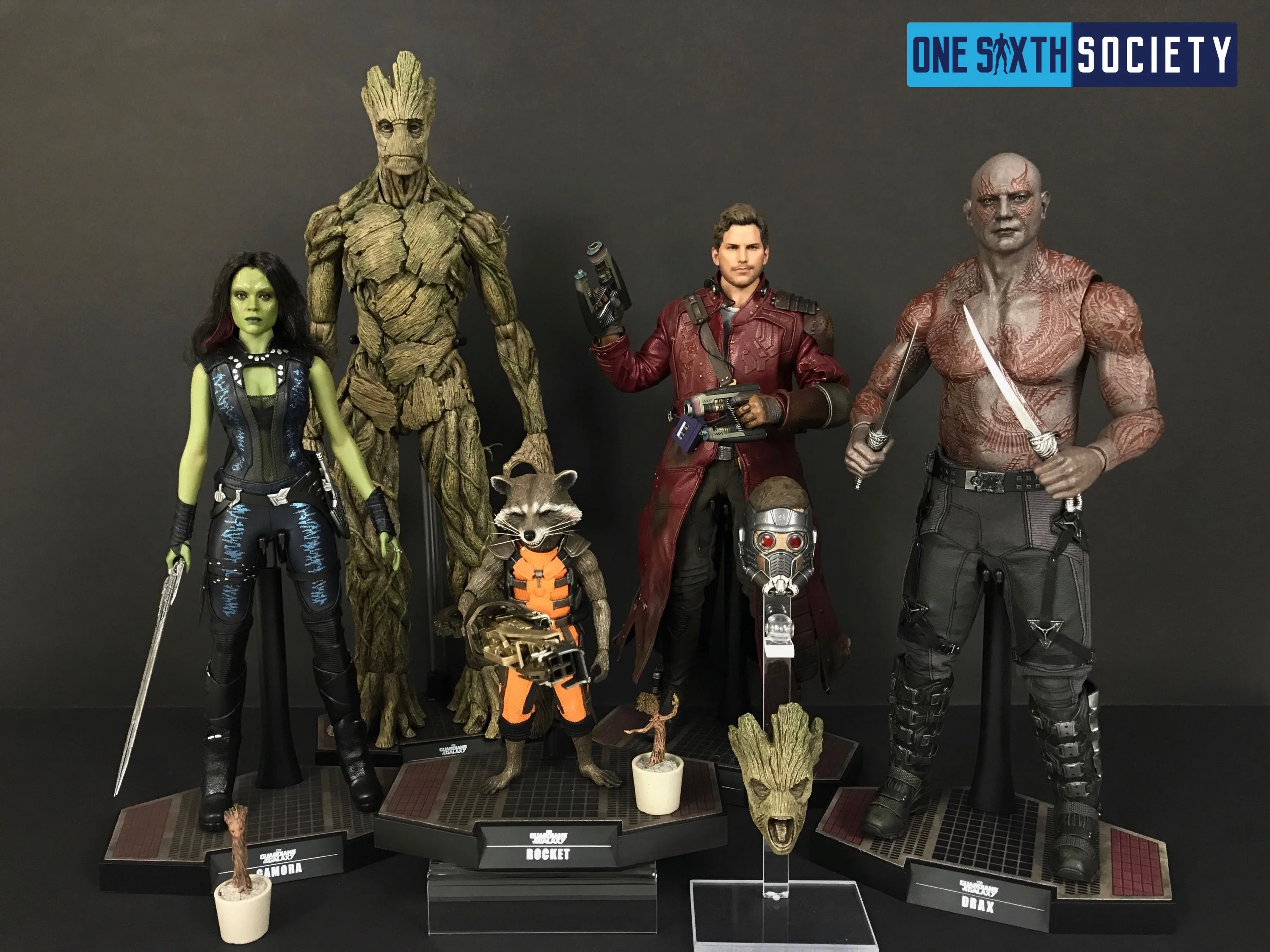 Hot Toys Gamora, Groot, Rocket, Star-Lord and Drax displayed together, with small Groot accessories along the front.