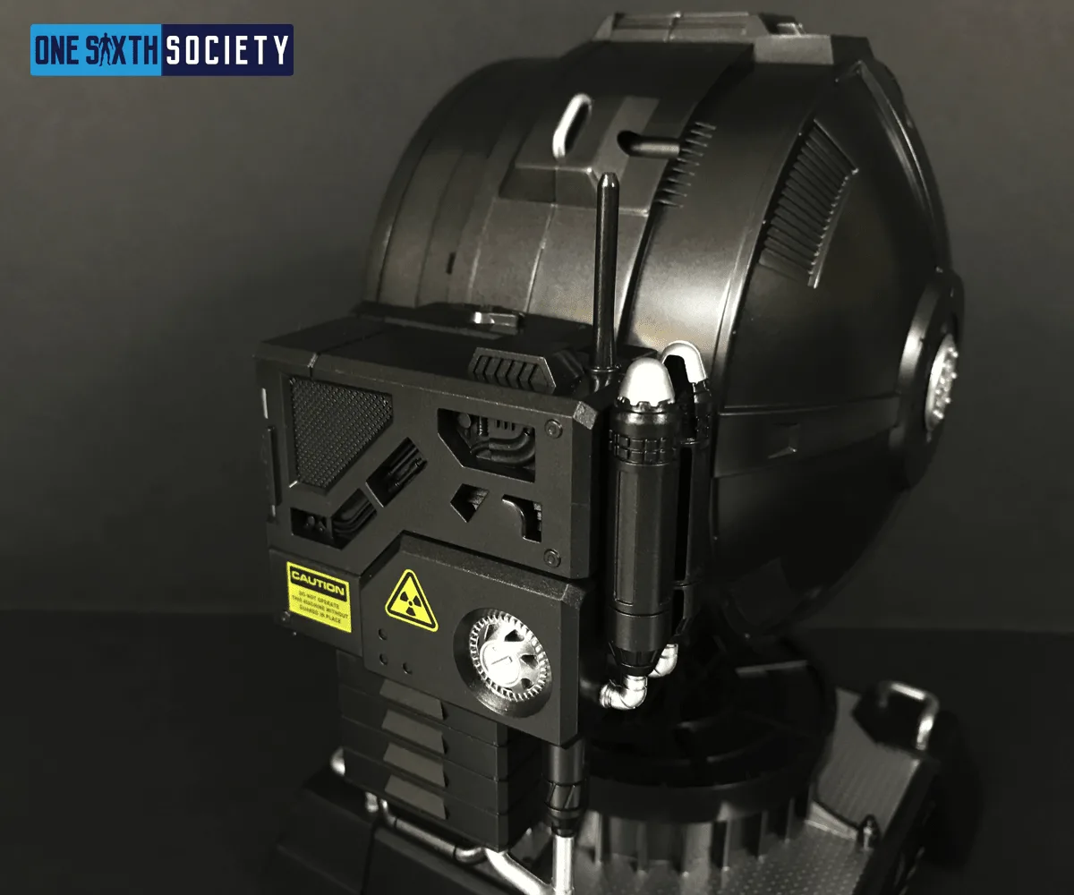 Angled rear close-up of the Hero Club spotlight showing housing vents, cables, warning labels and a small control box.