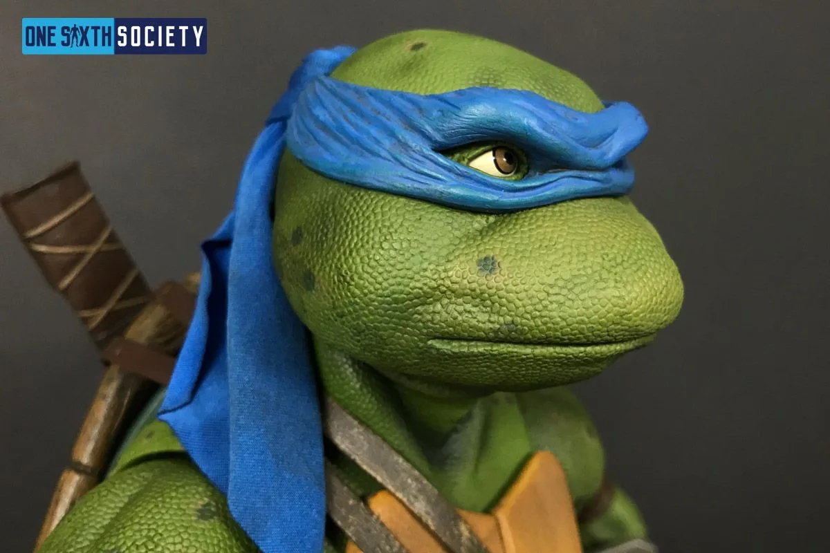 Angled portrait of NECA Leonardo showing the blue mask tails beside his neck and a sword handle behind his shoulder.