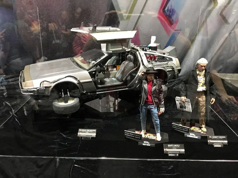 Wide Hot Toys Back to the Future display with the DeLorean’s doors raised and wheels turned for flight, plus Marty and Doc figures in front.