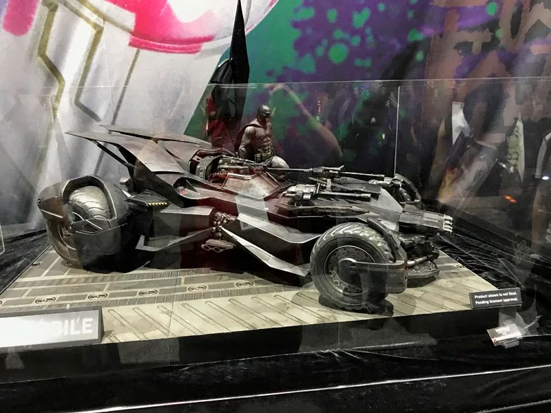 Hot Toys Batmobile shown from a front three-quarter angle on a patterned platform, with raised panels and Batman above the cockpit.