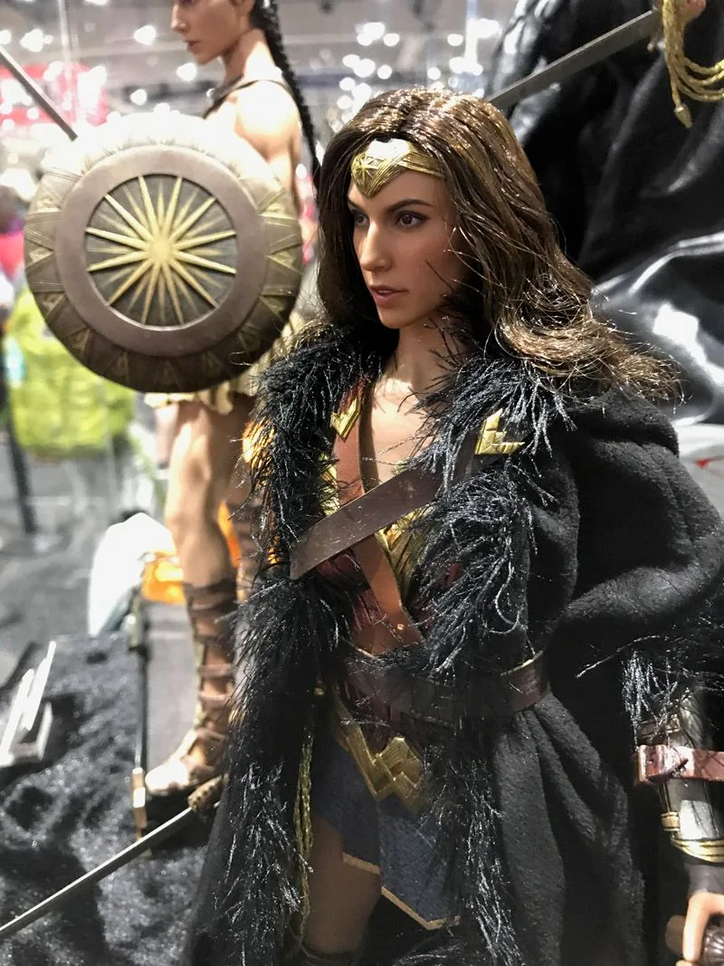 Hot Toys Wonder Woman wearing a gold tiara and dark cloak with a furry collar over her armor.