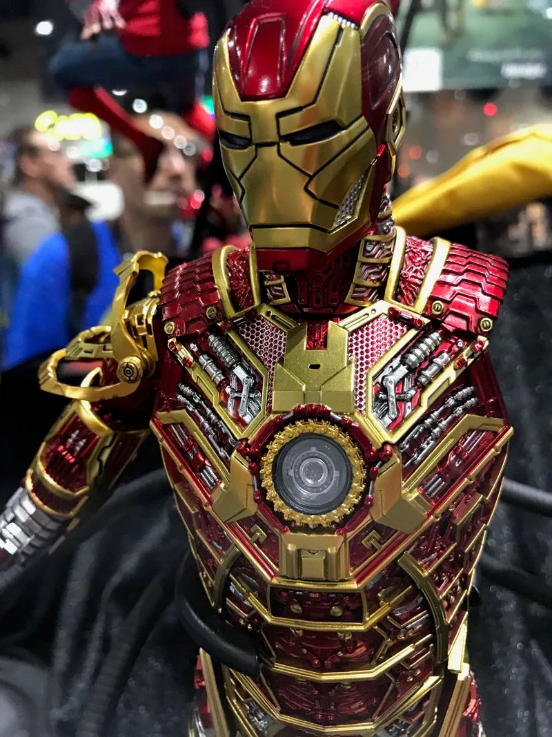 Close-up of Hot Toys Iron Man with exposed red-and-gold chest mechanisms surrounding a round arc reactor.