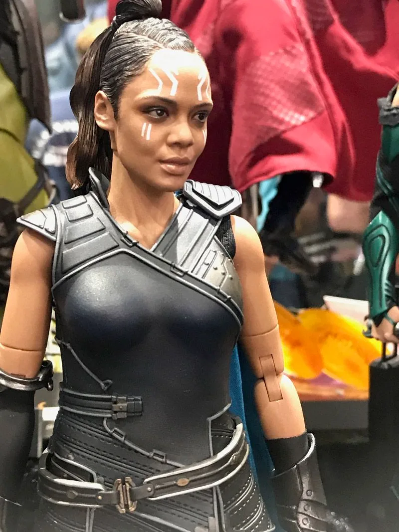 Hot Toys Valkyrie close-up showing white facial markings, tied-back hair and dark sleeveless armor.