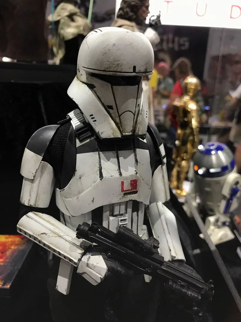 Hot Toys Imperial Assault Tank Commander in weathered white armor with a narrow black visor and red chest marking, holding a blaster.