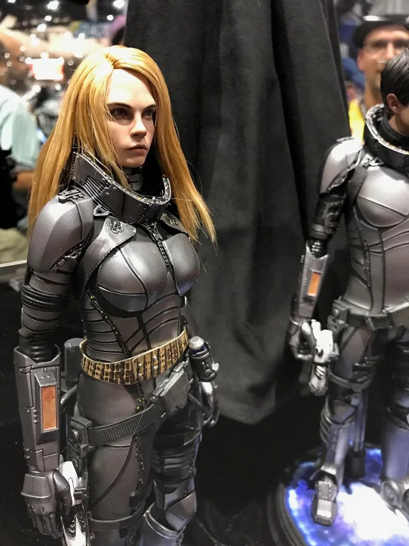 Hot Toys Laureline with long blonde hair and fitted gray segmented space armor, photographed from a three-quarter angle.