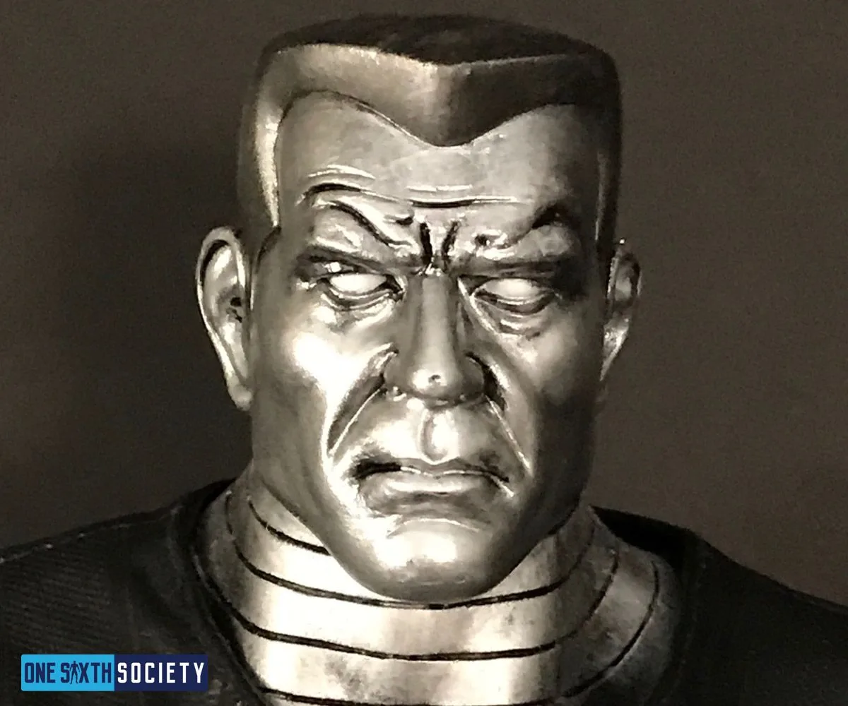 Close-up of Colossus's silver-painted face, black flat-top hair and segmented neck sculpt.