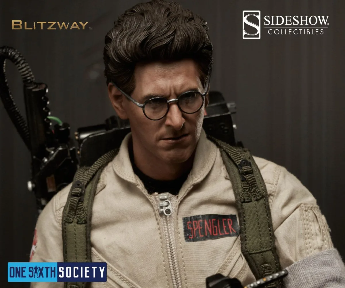 Egon Spengler figure with round glasses and tall swept-up hair, wearing a beige uniform with a Spengler name patch.