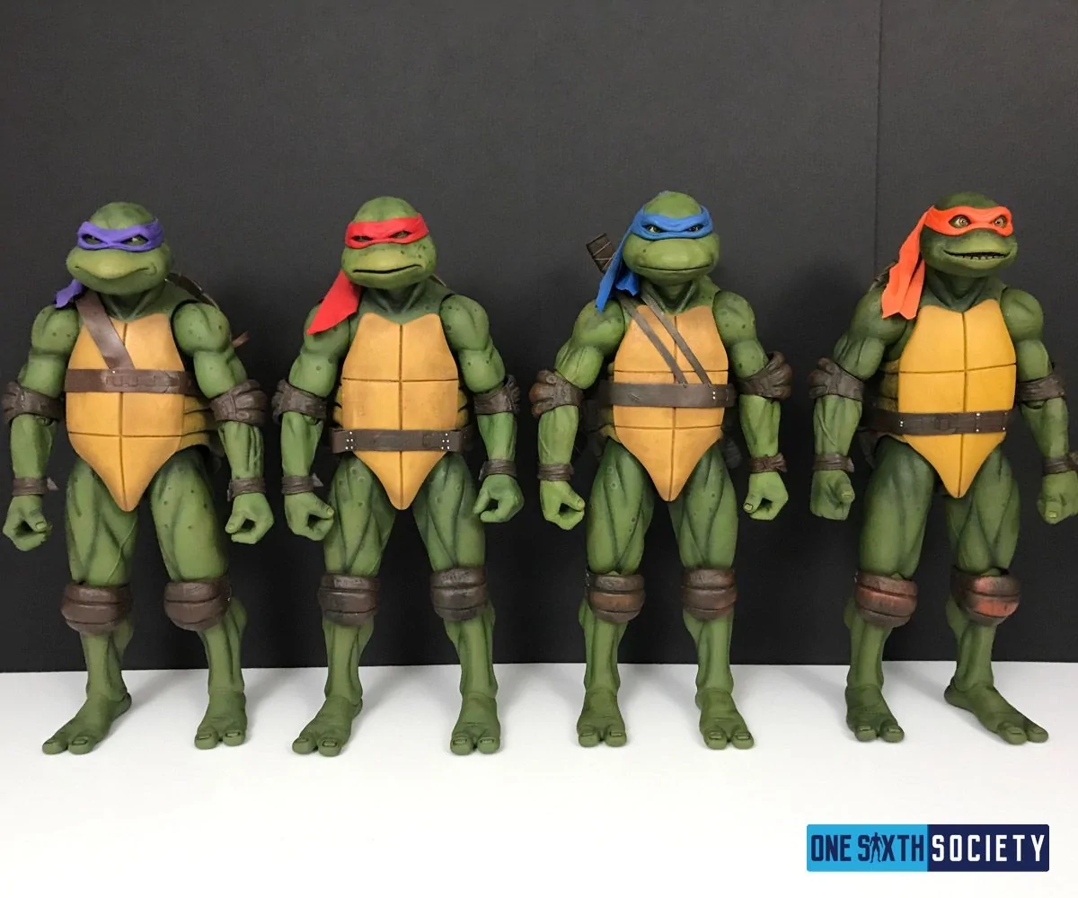 NECA movie Donatello, Raphael, Leonardo and Michelangelo standing side by side, wearing purple, red, blue and orange masks.