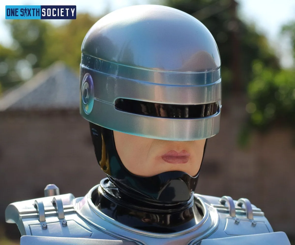 Close-up of the RoboCop bust's curved metallic-colored helmet, narrow black visor, exposed mouth and black chin guard.