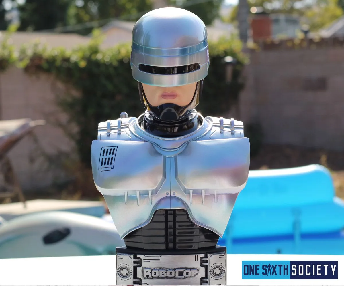 Front view of the RoboCop bust with silver-blue chest armor, black visor and a RoboCop nameplate on its base.