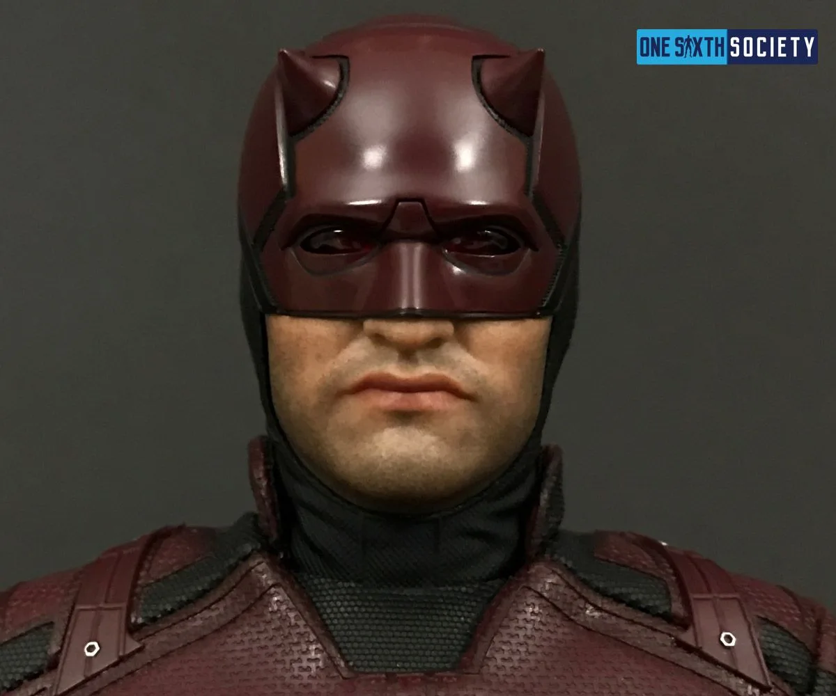 Close-up of the Daredevil figure's red cowl, small horns and neutral closed-mouth expression.