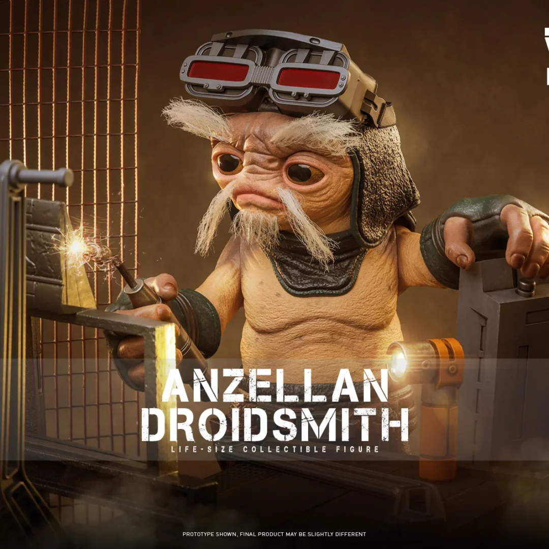 Hot Toys Anzellan Droidsmith at a workbench with a sparking welding torch, red-lensed goggles raised above his gray eyebrows and an orange flashlight nearby.