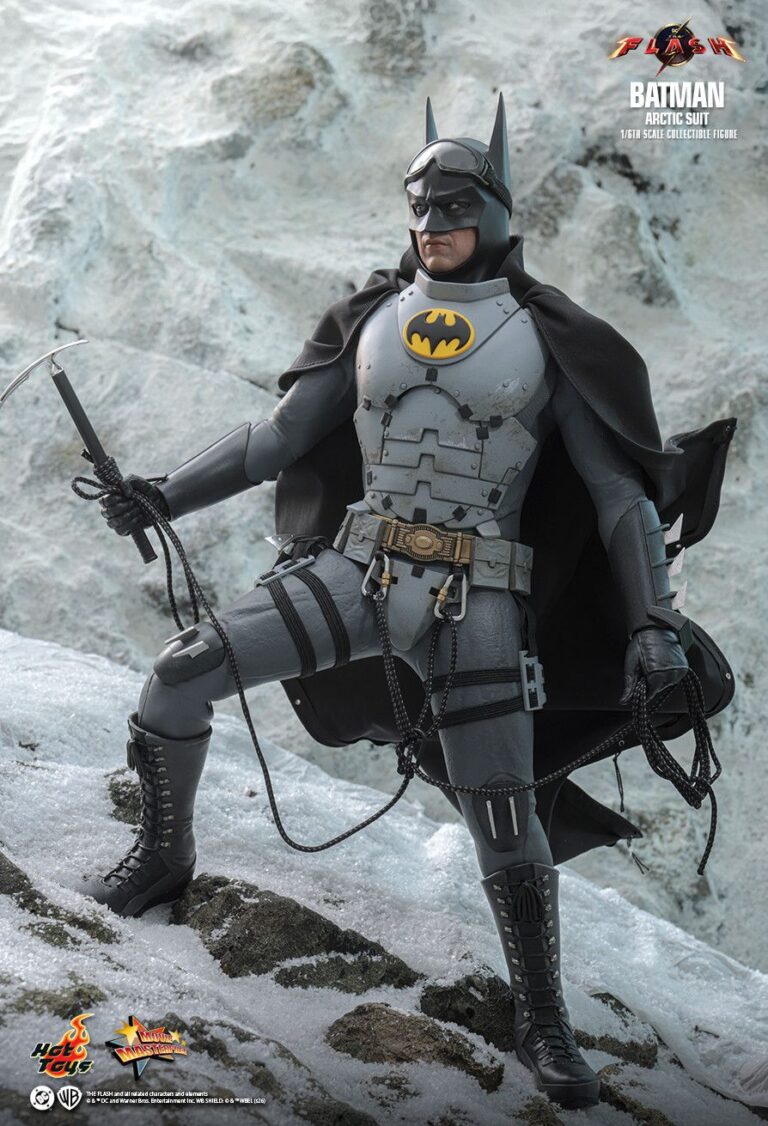 Batman using an ice axe and climbing rope in a snowy Arctic Suit display.