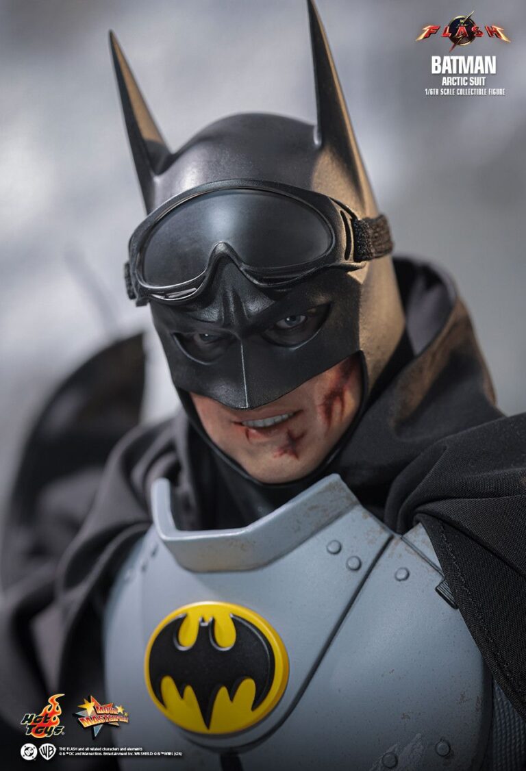 Close-up of Batman wearing snow goggles over the black cowl with a bloodied lower face.