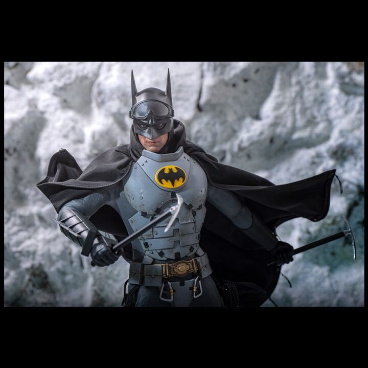 Batman standing in a snowy setting with the cape open around the Arctic armor.