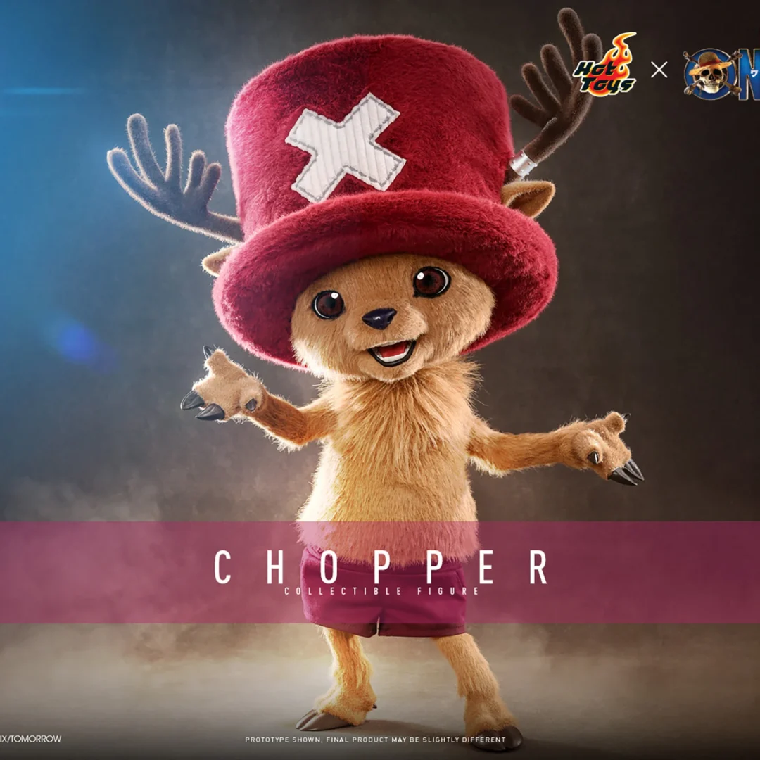Hot Toys Chopper smiling with both arms open, wearing a large red hat with a white cross and maroon shorts beneath his brown plush-covered body.