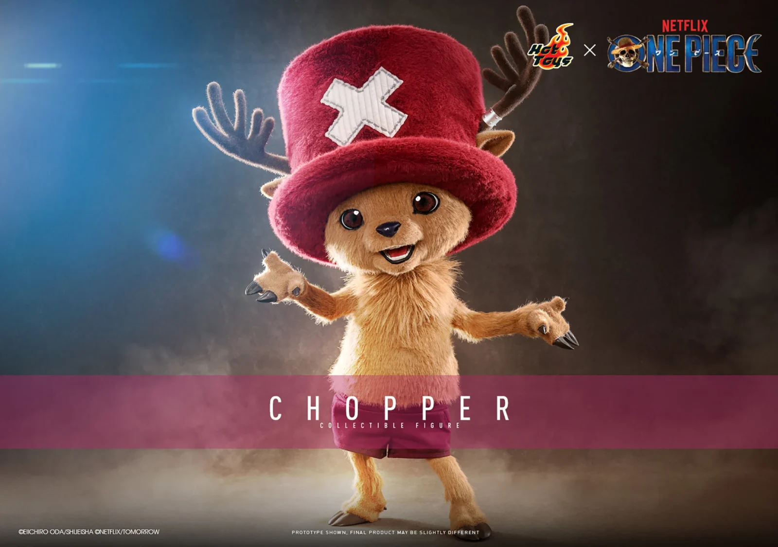 Hot Toys Chopper smiling with both arms open, wearing a large red hat with a white cross and maroon shorts beneath his brown plush-covered body.