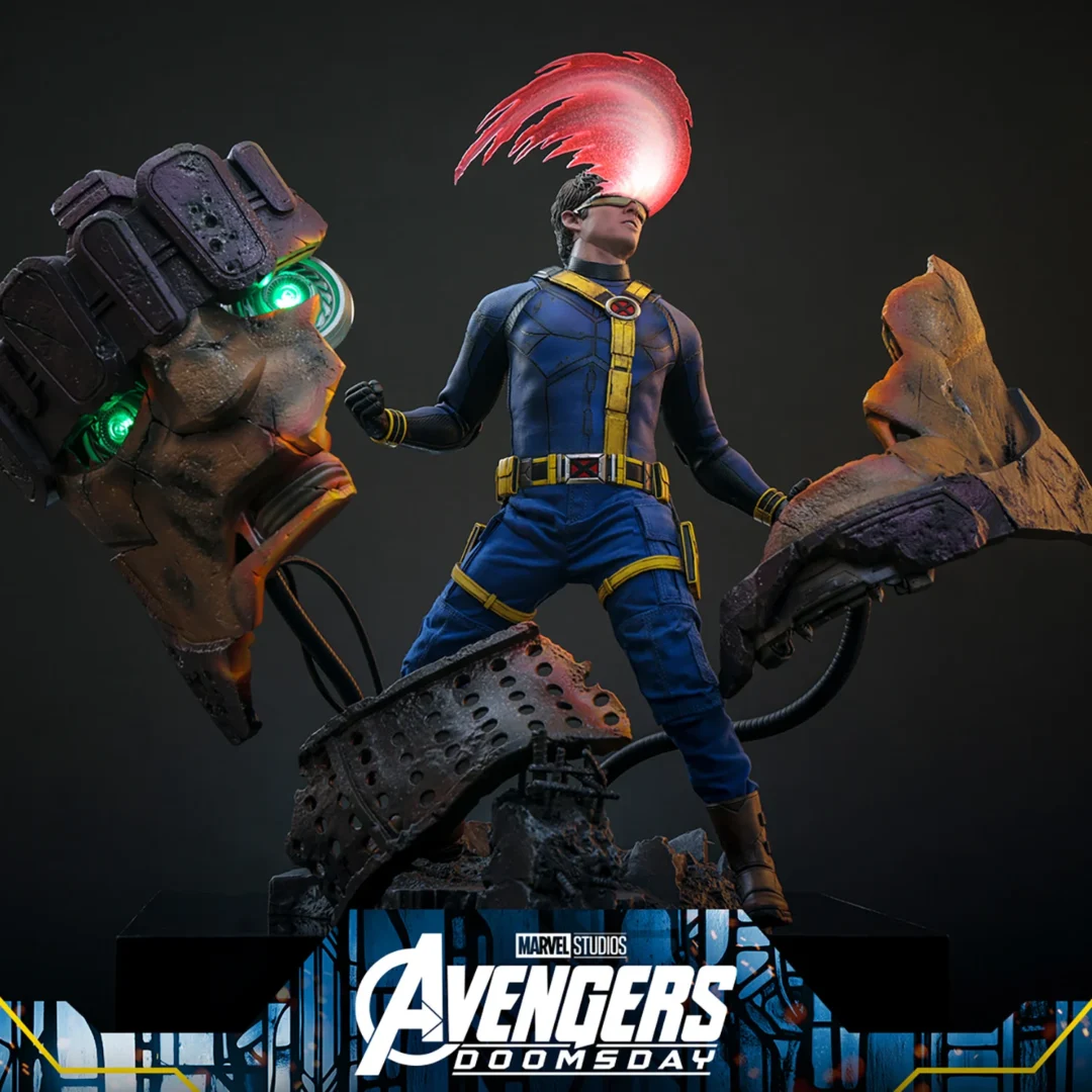 Hot Toys Cyclops in a blue-and-yellow X-Men suit, unleashing a curved red optic blast above the broken Sentinel head and scattered metal sections of the diorama.
