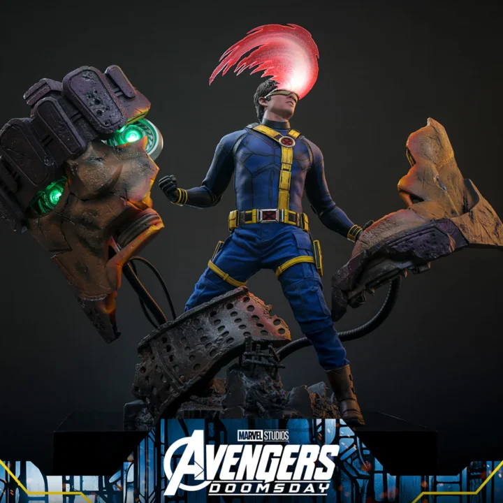 Hot Toys Cyclops in a blue-and-yellow X-Men suit, unleashing a curved red optic blast above the broken Sentinel head and scattered metal sections of the diorama.