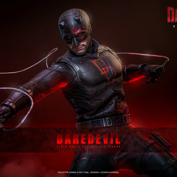 Hot Toys Daredevil swinging wire-linked Billy Clubs across a weathered black suit, with red mask markings and the red DD chest emblem under dramatic red light.