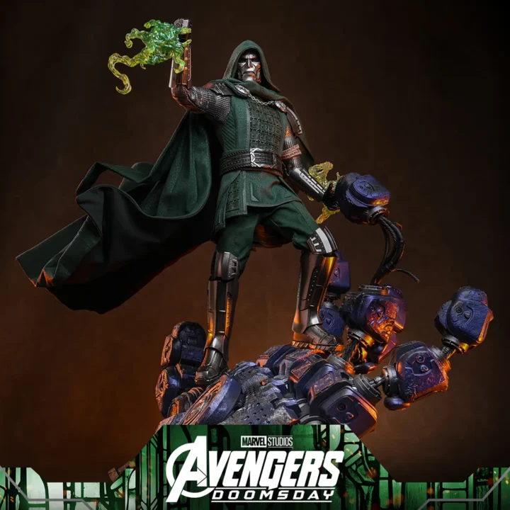 Hot Toys Doctor Doom in a green hood and silver armor, raising a translucent green flame while standing above the broken fingers of a Sentinel hand base.