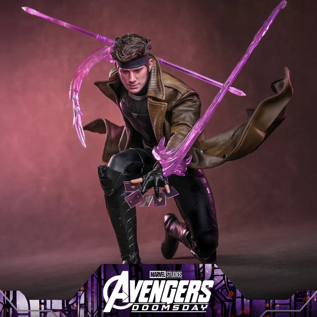Gambit crouching with the translucent purple staff across his shoulders, long energy trails above his hands and charged cards extended over the raised knee.