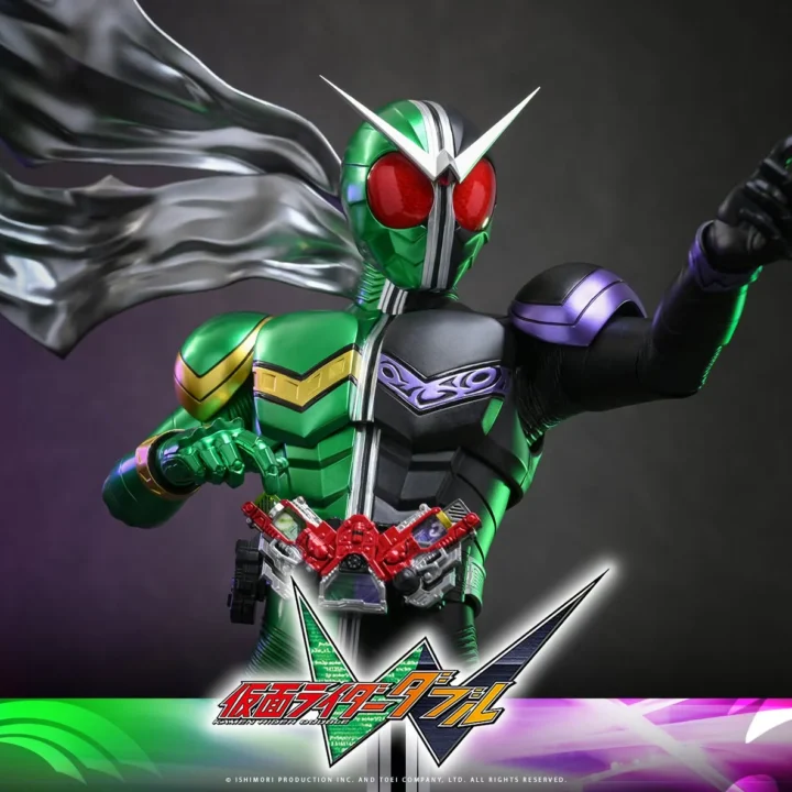 Kamen Rider W pointing forward with green Cyclone and black Joker armor
