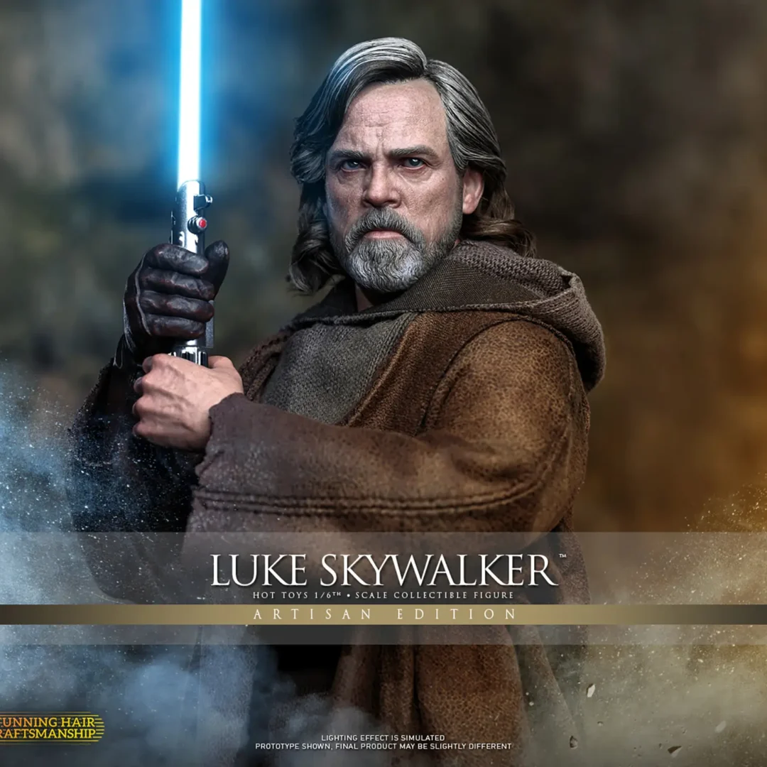 Hot Toys Luke Skywalker Artisan Edition gripping an upright blue lightsaber in both hands, with gray-streaked hair, a gray beard and layered brown island clothing.