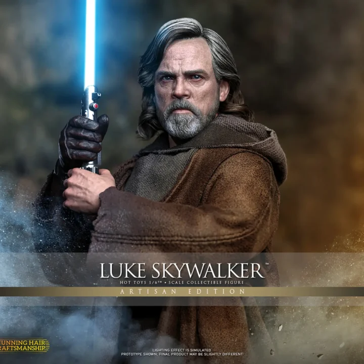 Hot Toys Luke Skywalker Artisan Edition gripping an upright blue lightsaber in both hands, with gray-streaked hair, a gray beard and layered brown island clothing.