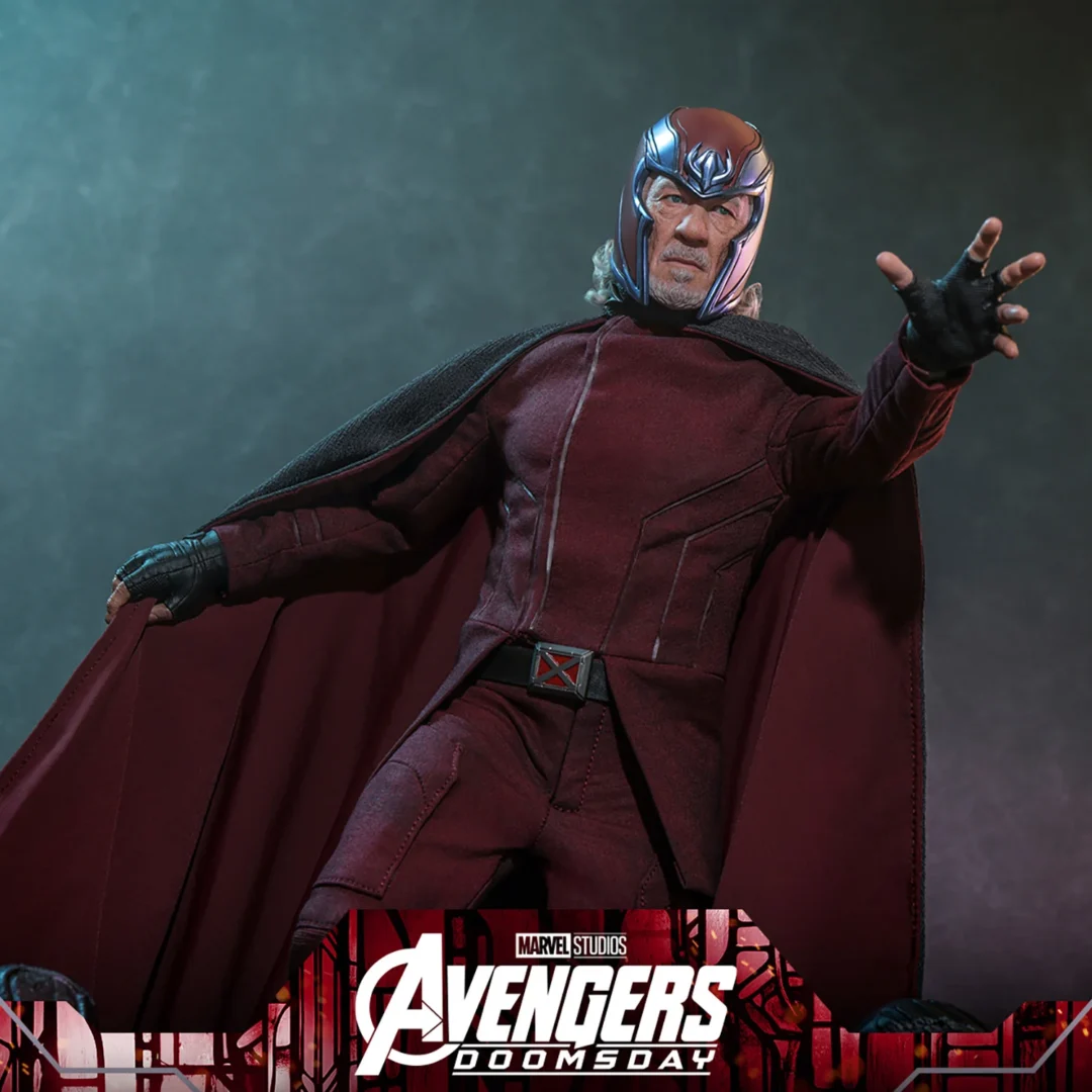 Hot Toys Magneto in a burgundy helmet and uniform, extending one hand among scattered robot fragments as his grey cape opens to reveal its burgundy lining.