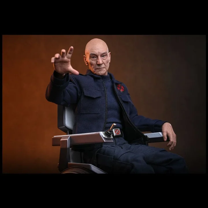 Wide portrait of Professor X extending an open hand from his wheelchair, his jacket partly open over the X-Men belt buckle against an orange background.