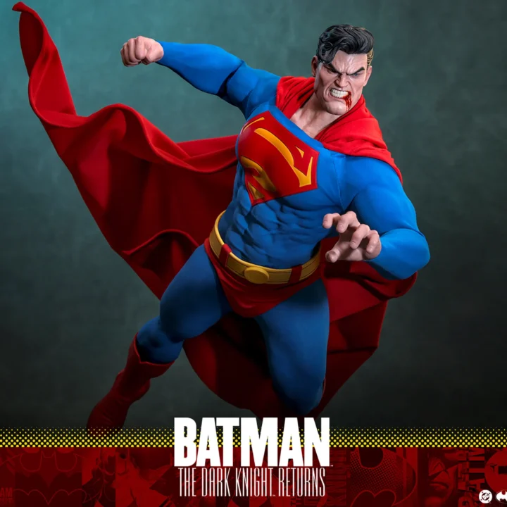 Wide view of Hot Toys Superman flying into a punch with one knee raised, a clenched-teeth expression and the red cape fanned around him.