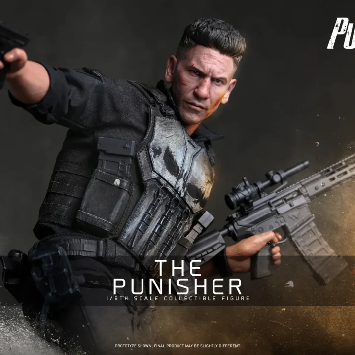 Hot Toys Punisher extending a pistol in one hand while holding a scoped rifle in the other, with a weathered white skull across his black tactical vest.