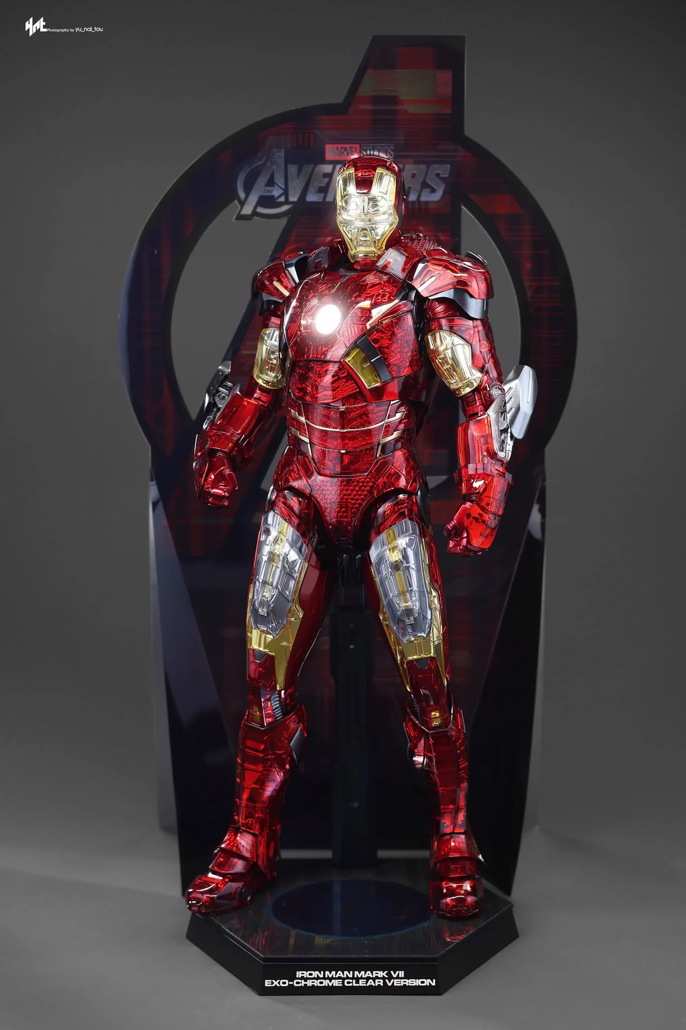 Final production review photo of Hot Toys Iron Man MK 7 Exo-Chrome showing the figure on its display base with the included backdrop.