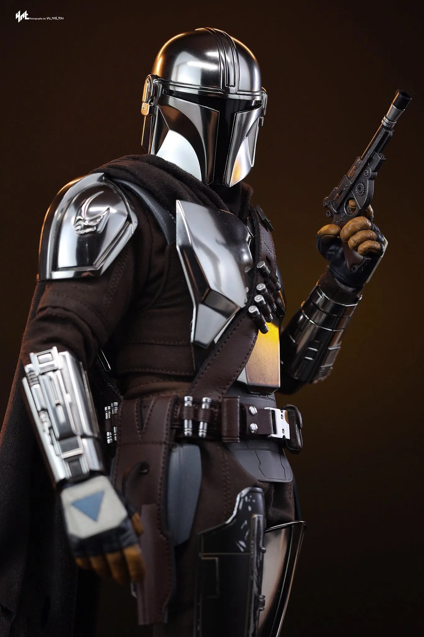 Final production review photo of Hot Toys Mandalorian & Grogu showing the chrome helmet, chest armor and blaster.
