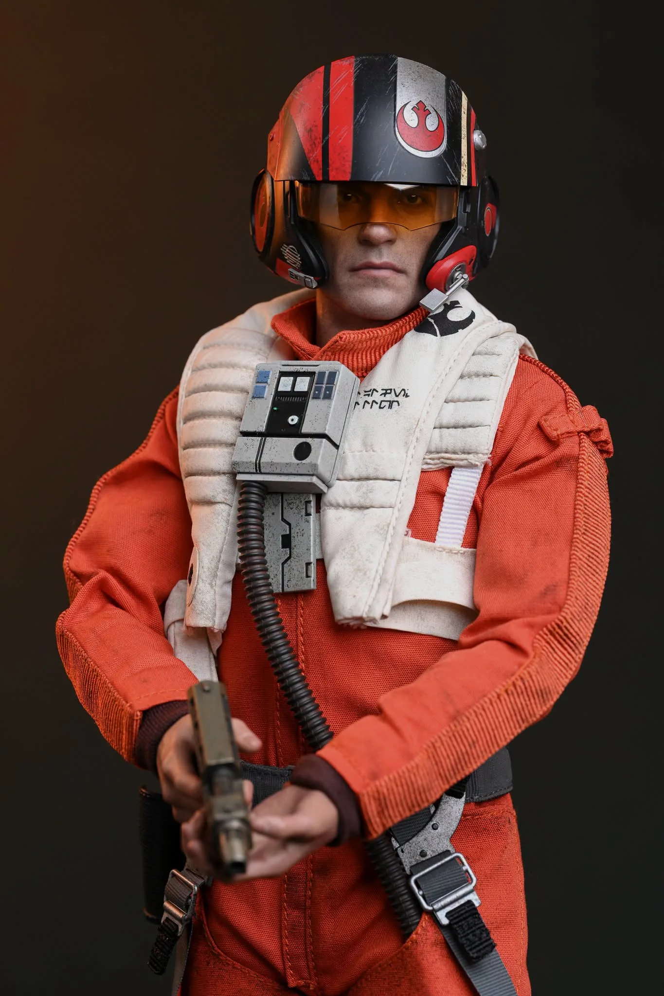 Final production review photo of Hot Toys Poe Dameron showing Poe wearing the pilot helmet and holding his blaster.