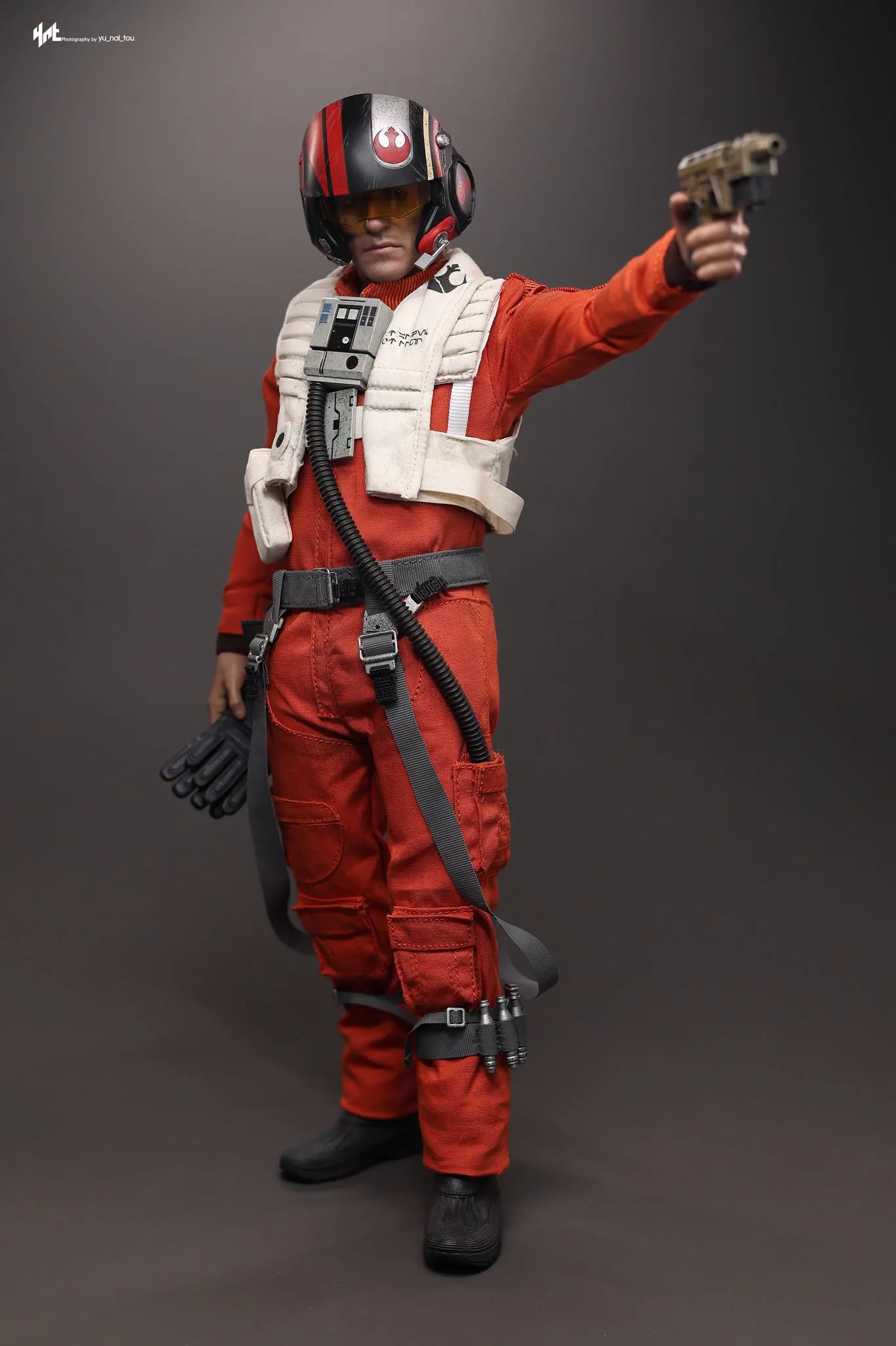 Final production review photo of Hot Toys Poe Dameron showing the helmeted figure aiming his blaster.