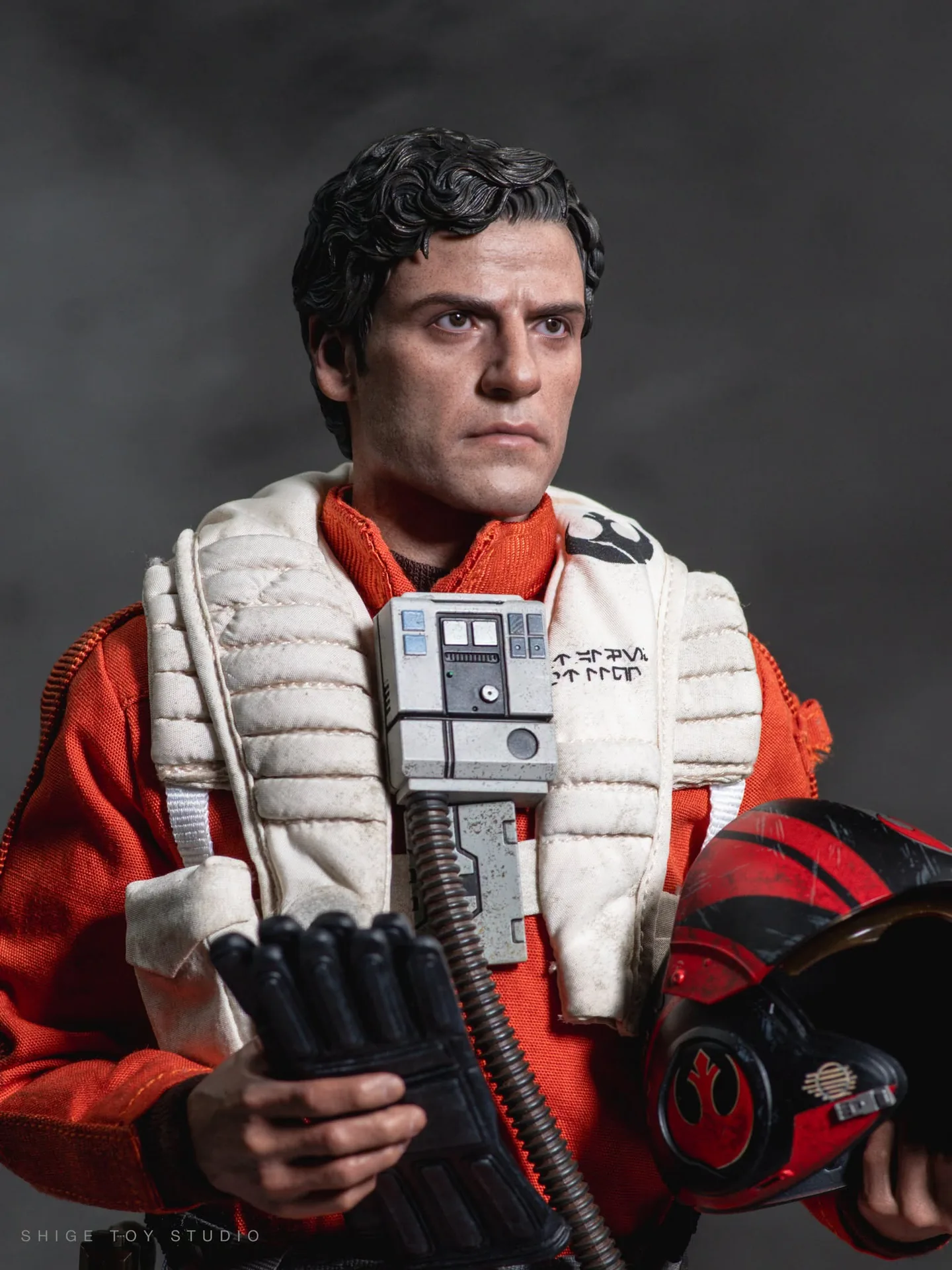Final production review photo of Hot Toys Poe Dameron showing the orange flight suit, chest box, helmet and gloves.