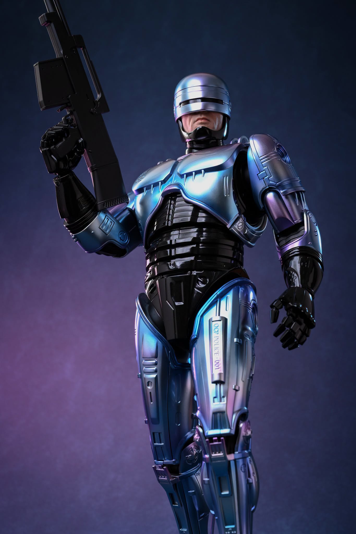 Hot Toys RoboCop 2 holding the Cobra Assault Cannon against a plain blue-purple background.