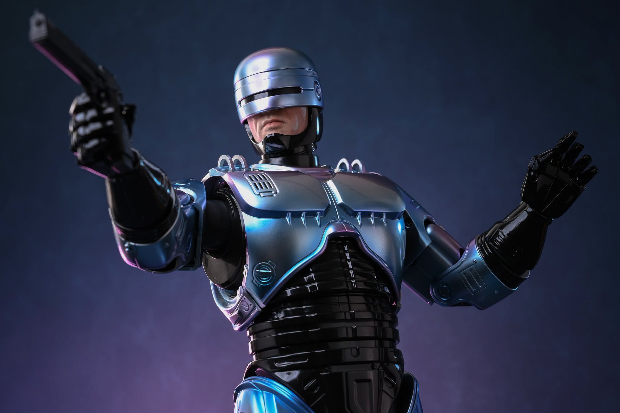 Hot Toys RoboCop 2 helmet, faceplate and blue-purple metallic chest armor with an Auto-9 pistol.